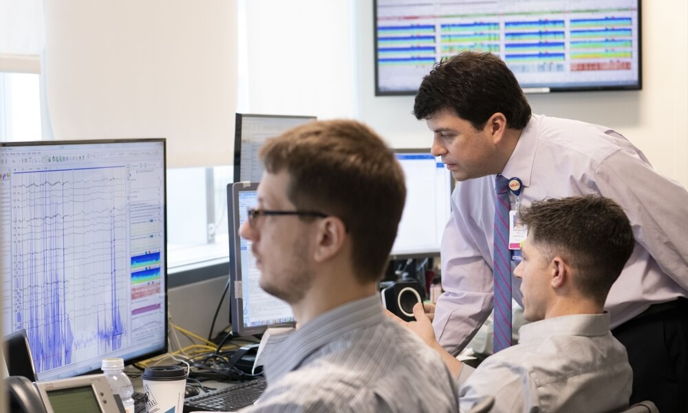 A doctor consults with monitoring specialists A doctor consults with monitoring specialists